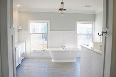 a large white bath tub sitting inside of a bathroom