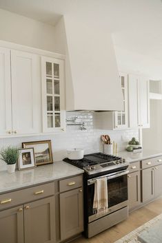 a kitchen with an oven, stove and pictures on the counter top in front of it