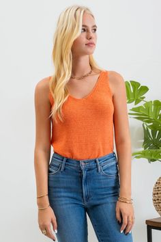 Our Lightweight Sweater Tank is the perfect staple piece for your wardrobe, providing a lightweight and versatile option for both summer and year-round wear. Also available in other colors. Lightweight, knit tank top Fits true to size 55% acrylic, 45% nylon Machine wash gentle cycle, hang dry Casual Knit V-neck Tank Top, Orange Knit V-neck Top, Orange V-neck Knit Top, Trendy Textured Knit Sweater Vest For Summer, Knit V-neck Tank Top For Day Out, Casual Seamless Vest, Casual Seamless Summer Vest, Casual Textured Knit Tank Top For Fall, Casual Tank Sweater Vest For Vacation