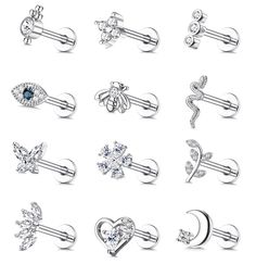 six pairs of piercings with different shapes and sizes, including an arrow, heart, flower