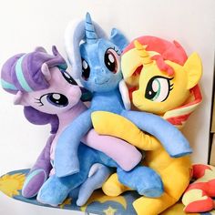 several stuffed animals sitting on top of each other