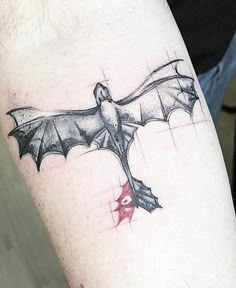 a tattoo on the arm of a man with a bat