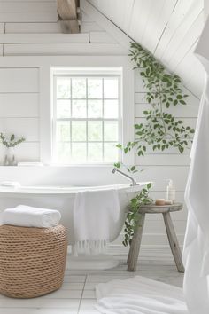 a bathroom with white walls and flooring has a wicker basket on the side