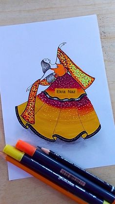 a card with an image of a woman in a colorful dress on it next to markers