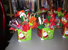 several christmas candy in small green buckets on a table