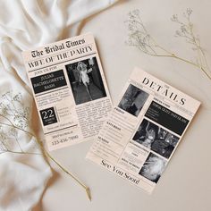 two newspaper articles sitting on top of a bed next to dried flowers and white sheets