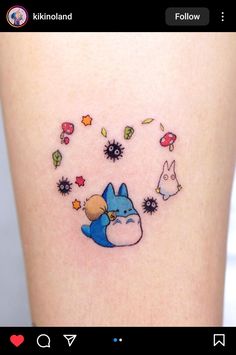 a small tattoo on the side of a woman's leg with an image of a cartoon character