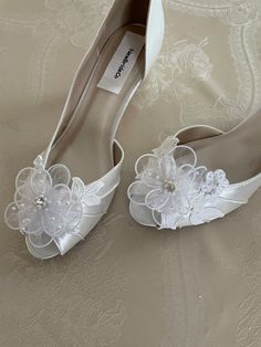 white wedding shoes with flowers on them