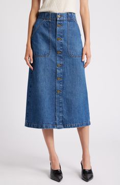 Exposed front buttons and angled patch pockets bring retro appeal to this midi skirt cut from soft denim in the perfect indigo wash. 32" length (size 29) Front button closure Front patch pockets; back patch pockets Unlined 80% regenerative cotton, 20% recycled cotton Machine wash, dry flat Imported