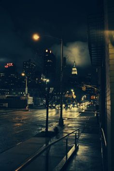 an empty city street at night in the rain