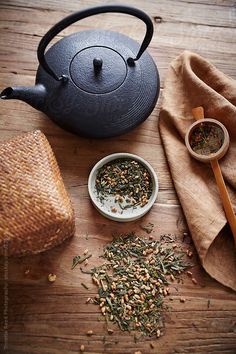 a tea pot and some spices on a wooden table