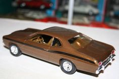 a brown toy car sitting on top of a table