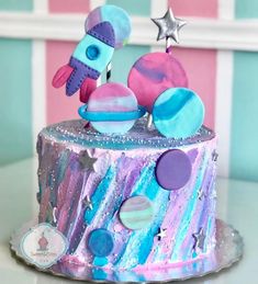 a colorful cake decorated with space and stars