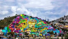 a large colorful building on top of a hill