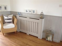 a chair sitting next to a white radiator in a room with wood floors