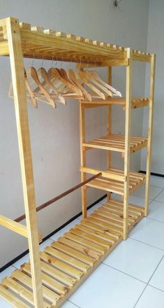 a wooden bunk bed sitting on top of a white tiled floor next to a wall