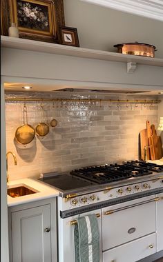 a stove top oven sitting inside of a kitchen