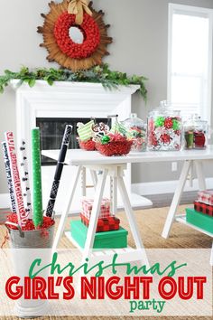 a table with christmas decorations on it in front of a fireplace