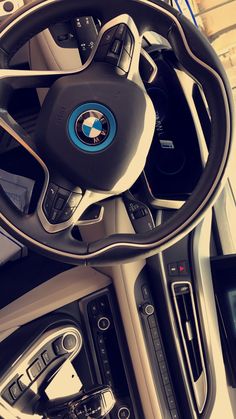 the interior of a car with steering wheel and dashboard controls