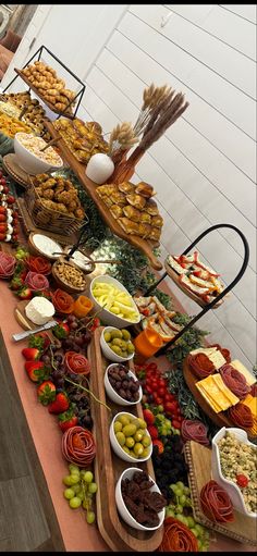 a buffet table filled with lots of different types of foods and desserts on it