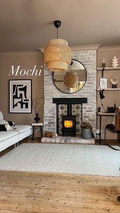 a living room filled with furniture and a fire place under a mirror on the wall