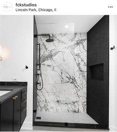 a bathroom with black and white marble walls