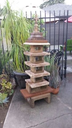 an outdoor fountain made out of wooden blocks