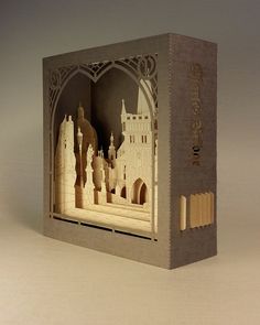 an open book with cut out architecture on the front and inside, featuring a castle