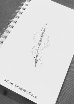 an open notebook with a drawing of a flower on it