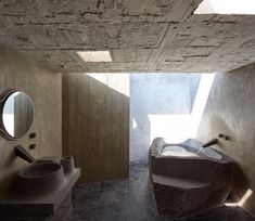 the interior of a bathroom with stone walls and flooring is shown in this image