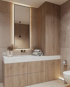 a bathroom with a sink, mirror and toilet in it's center wall area