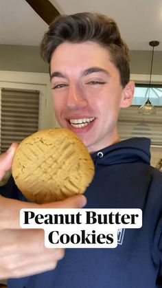 a man holding a peanut butter cookie in front of his face with the words peanut butter cookies on it