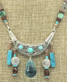 "Boho Turquoise Natural Stone Jewelry Set. Necklace and Earrings. Sw. Austrian Crystal Large Turquoise Drop on Necklace Focal. Earrings with Beaded Tassels. Magnetic Rhinestone Clasp. Jesse James Beads * Sw. Austrian Crystal Large focal drop *Turquoise  *Boho *Rhinestone Magnetic Clasp  *Necklace 18\" *Beaded Tassels *Turquoise Natural Stone *Necklace $45.00 *Earrings $15.50" Turquoise Costume Jewelry With Dangling Beads, Bohemian Turquoise Jewelry Sets For Gifts, Turquoise Dangling Beads Costume Jewelry, Turquoise Dangle Costume Jewelry Necklace, Turquoise Dangle Costume Jewelry Necklaces, Turquoise Dangle Necklace Costume Jewelry, Handmade Bohemian Turquoise Jewelry Sets, Turquoise Dangle Necklaces In Costume Jewelry Style, Handmade Turquoise Bohemian Jewelry Sets