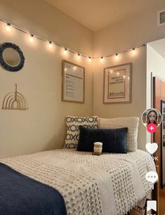 a bed room with a neatly made bed and string lights