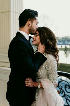 a bride and groom kissing in front of the lincoln memorial