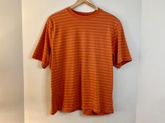 This is a 90s / Y2K era orange striped skater style t-shirt made by Penman's. 100% cotton material. It is a US Mens Size L. In good vintage condition - please review all photos for details! Approx. measurements laying flat: ~25 inch length ~23 inches pit to pit ~9 inch sleeve ⊹ Bundle Discounts ⊹ Buy 2 items and save 20% with code: BUY2SAVE20 Buy 3 or more items and save 30% with code BUY3SAVE30 Retro Striped T-shirt For Streetwear, 90s Striped Crew Neck Top, Striped 90s Style T-shirt For Summer, 90s Striped T-shirt For Summer, Striped 90s Style Summer T-shirt, 90s Striped Cotton T-shirt, 90s Striped Short Sleeve T-shirt, Y2k Era, Brown And Orange