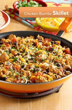 a skillet filled with mexican food on top of a wooden table