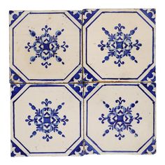 four blue and white tiles with an ornate design on the bottom one is in square shape