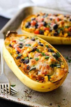 two stuffed squash boats with black beans and corn on top, ready to be eaten