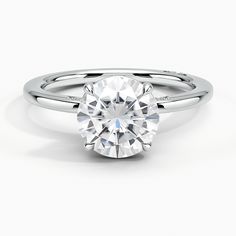 a round brilliant cut diamond ring on a white background, with the center stone visible