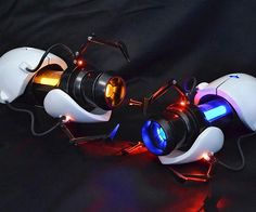 two white and blue computer mice with red lights on their heads, sitting next to each other