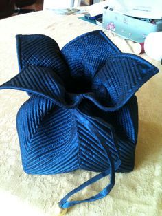 a blue bow sitting on top of a bed