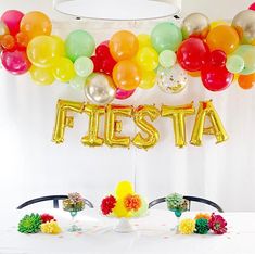 there is a festa sign and balloons on the table