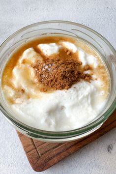 a glass bowl filled with whipped cream and cinnamon