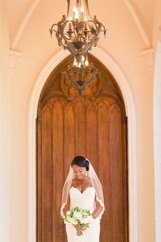 a bride standing in front of a church door