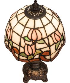 a stained glass lamp sitting on top of a table