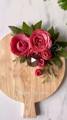 a wooden cutting board with flowers on it