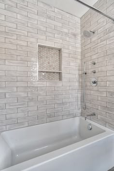 a white bath tub sitting next to a walk in shower