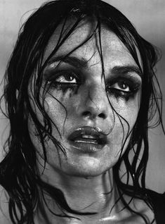 a black and white photo of a woman with makeup