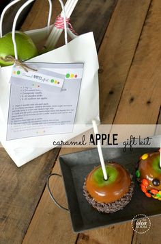 there are two donuts with candles in them on the table next to a paper bag